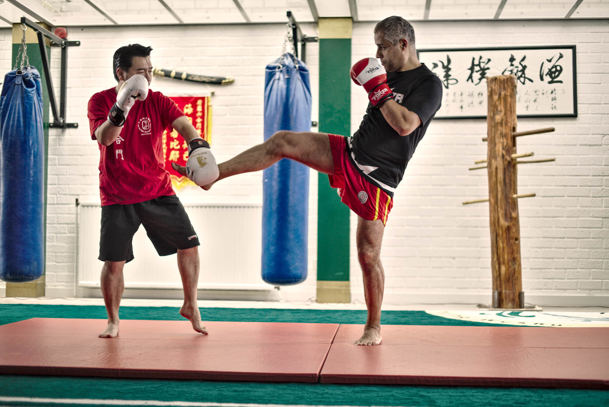 Two men fighting red boxing gloves